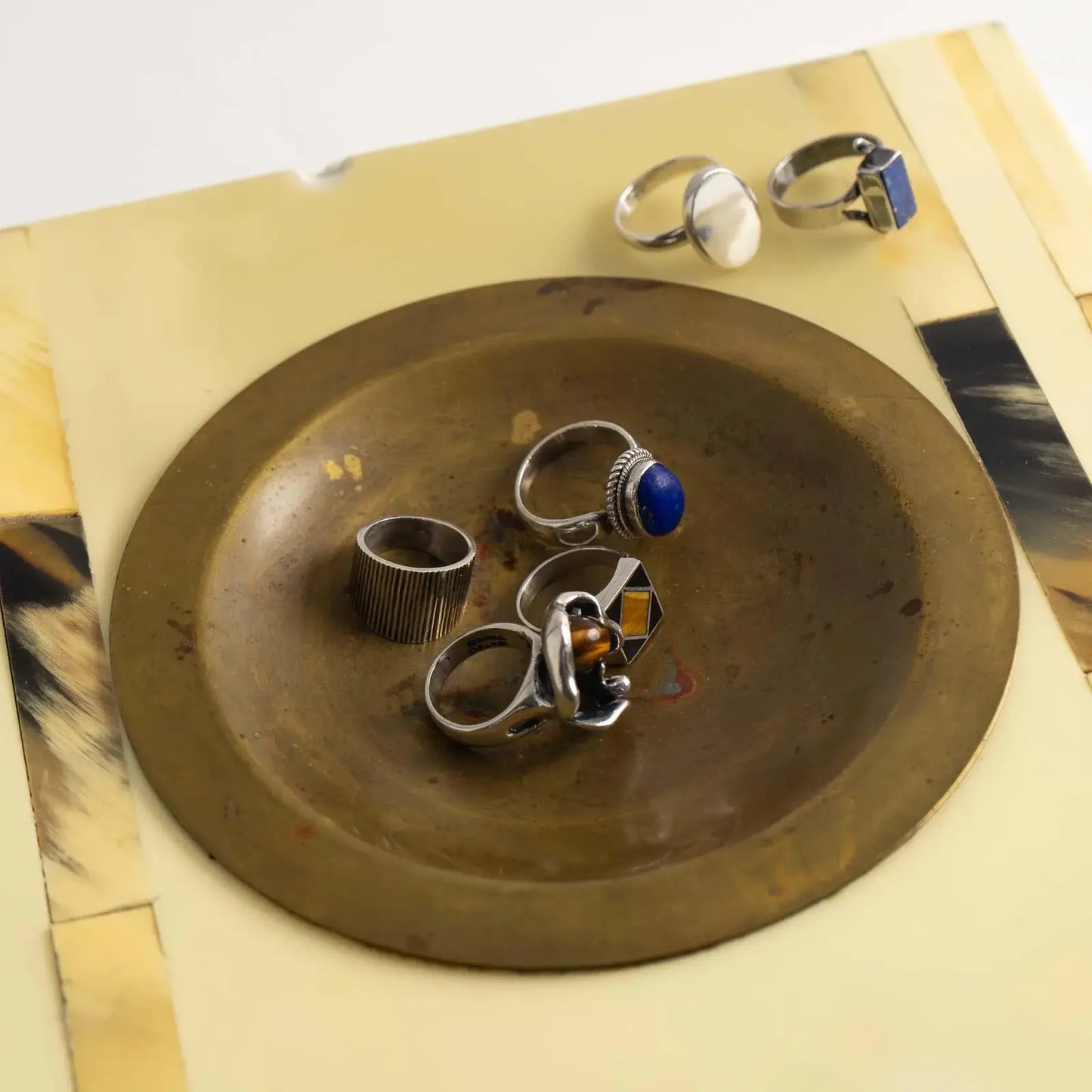 Vintage square horn inlay catchall with round brass ashtray center, shown as a jewelry holder