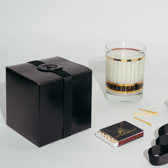 vintage gold and black striped candle with black gift box with ribbon, wax and the vintage advisor matches