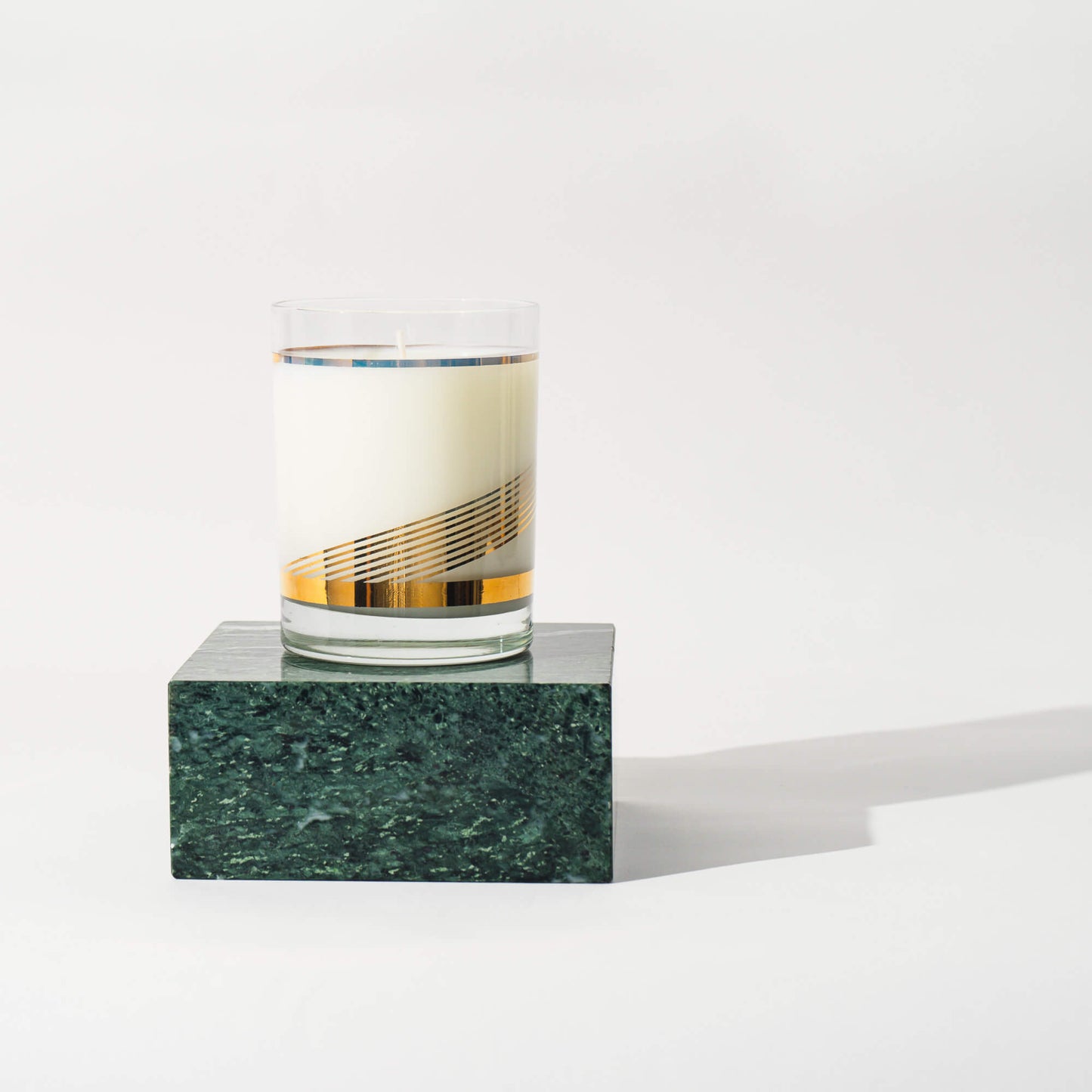 Load image into Gallery viewer, Vintage Gold Swirl Glass Candle on a green marble block
