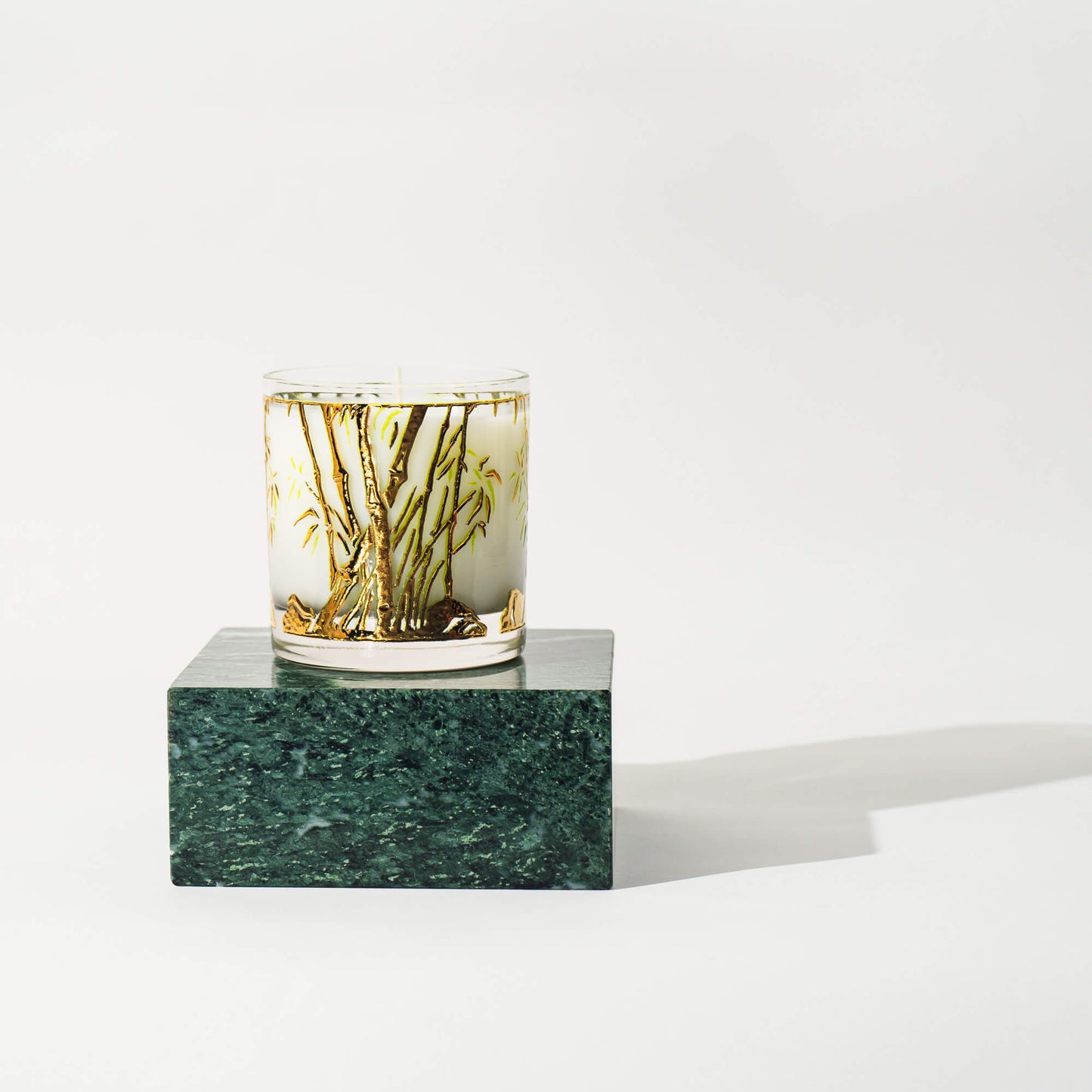 Vintage Bamboo Glass Candle on green marble block 