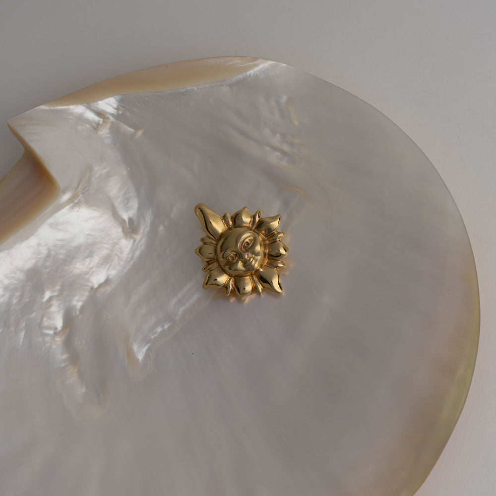 
                  
                    vintage 14k gold puffy smiling cosmic sun pendant on abalone shell 
                  
                