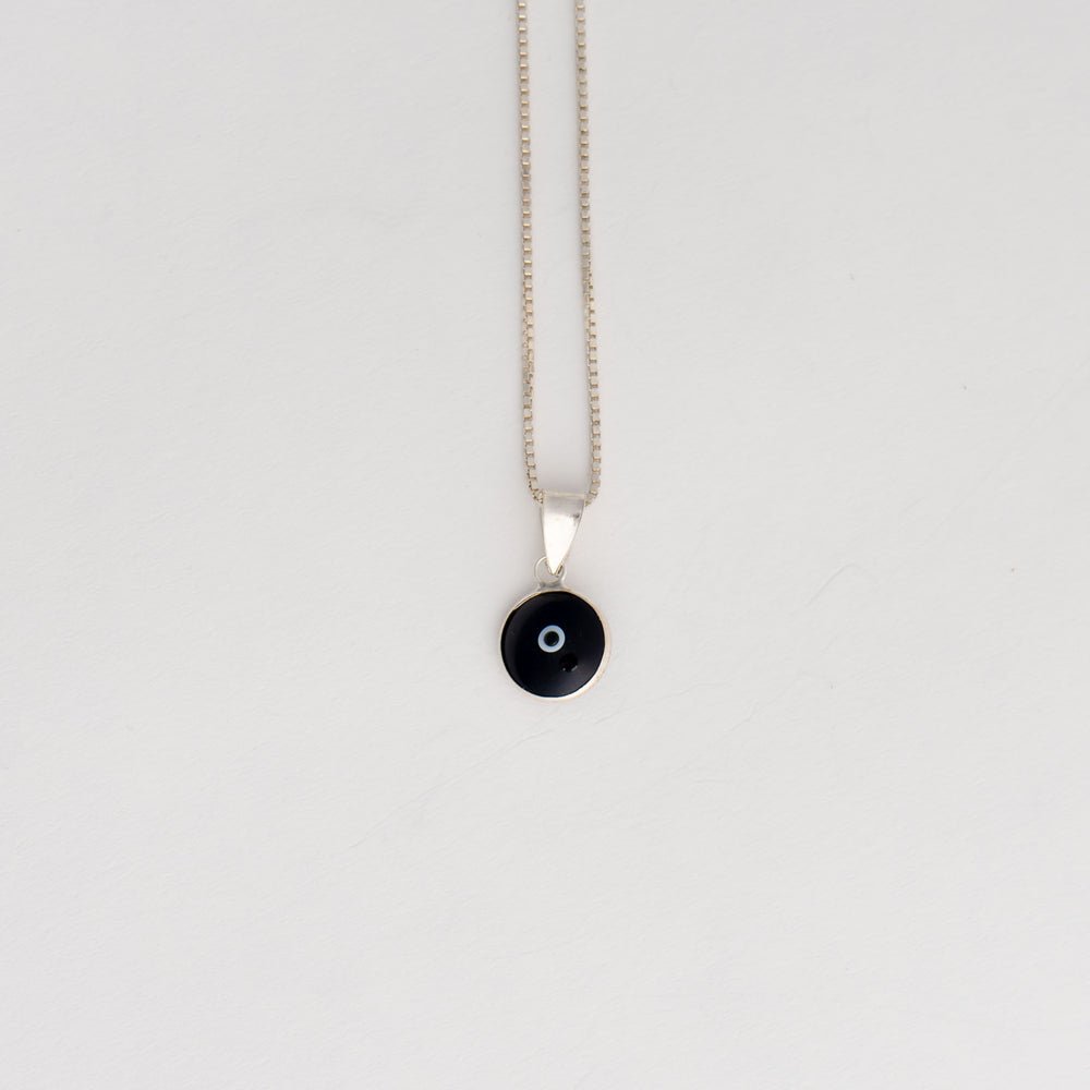 
                  
                    minimalist protective evil eye charm in black with sterling silver
                  
                