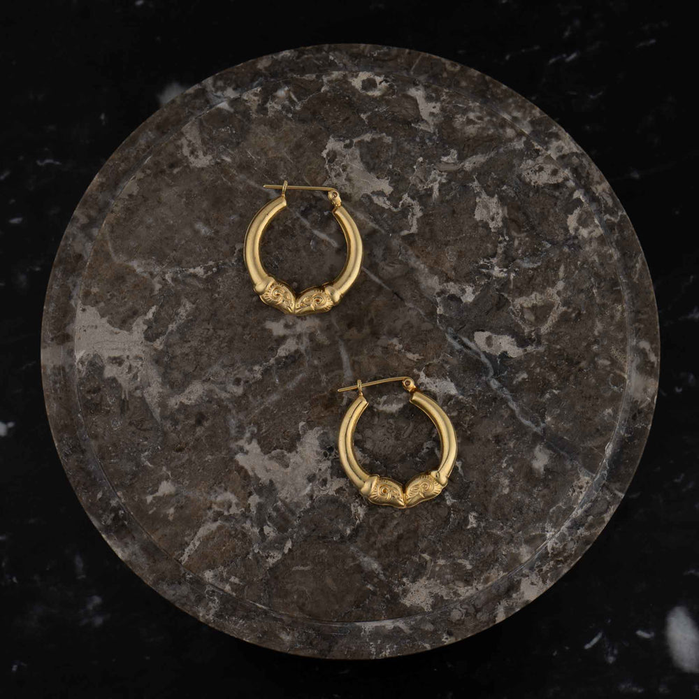 
                  
                    vintage 14k gold ram's head hoop earrings
                  
                