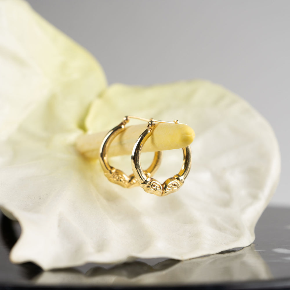 
                  
                    vintage 14k gold ram's head hoop earrings
                  
                