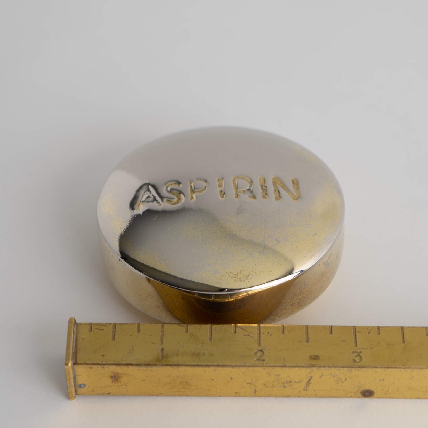 Load image into Gallery viewer, vintage brass aspirin paperweight desk decor
